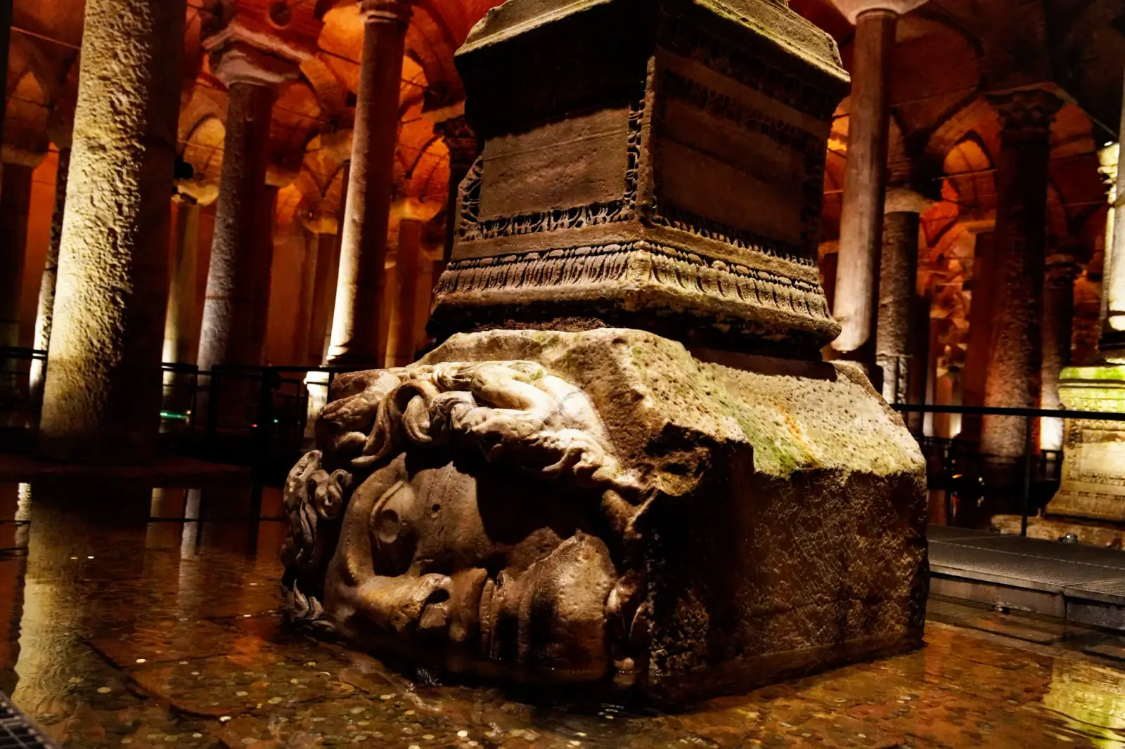 The sideways Medusa block carrying a column, the forest of shafts and lit vaults behind it.